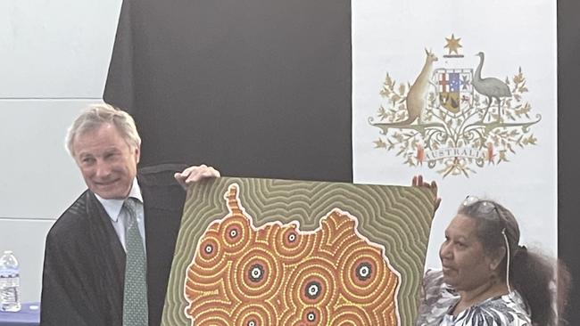 Justice Steven Rares was presented with a traditional artwork by Aunty Lois Johnson painted by Gilbert Laurie. Justice Rares told the assembly the artwork would be displayed in a prominent spot at the Federal Court.