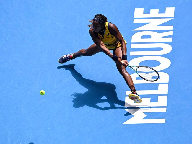 TOPSHOT - USA's Coco Gauff hits a return against Ukraine's Marta Kostyuk during their women's singles quarter-final match on day 10 of the Australian Open tennis tournament in Melbourne on January 23, 2024. (Photo by WILLIAM WEST / AFP) / -- IMAGE RESTRICTED TO EDITORIAL USE - STRICTLY NO COMMERCIAL USE --