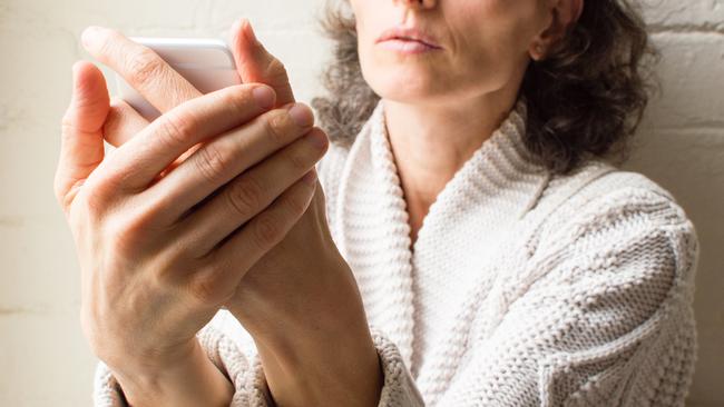 Middle aged woman holding phone