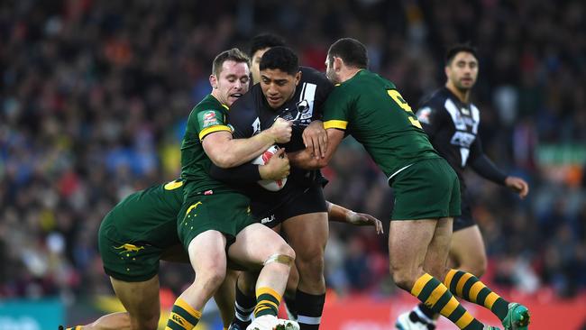 Jason Taumalolo of New Zealand is held up by the Australia defence.