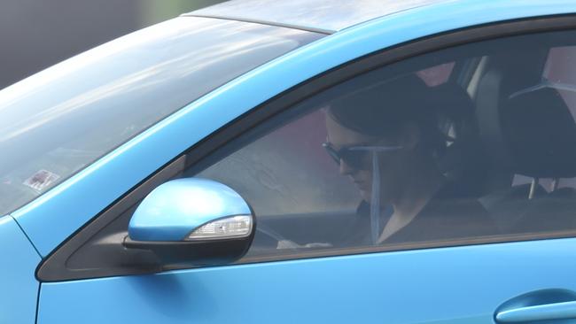 A woman appears to be texting while in the car, which is illegal unless legally parked. Picture: Evan Morgan