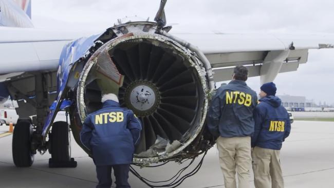 A National Transportation Safety Board investigator examines damage to the engine of the Southwest Airlines plane. Picture: NTSB via AP.