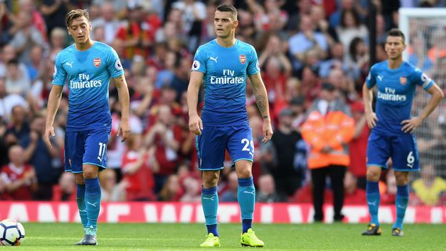 LIVERPOOL, ENGLAND - AUGUST 27:  Mesut Ozil of Arsenal are Granit Xhaka of Arsenal are dejected after Liverpool's fourth goal during the Premier League match between Liverpool and Arsenal at Anfield on August 27, 2017 in Liverpool, England.  (Photo by Michael Regan/Getty Images)