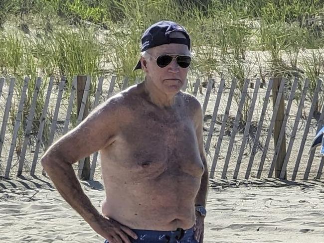 A picture showing US President Joe Biden. sunning himself shirtless on the beach near his Rehoboth, Delaware, home.