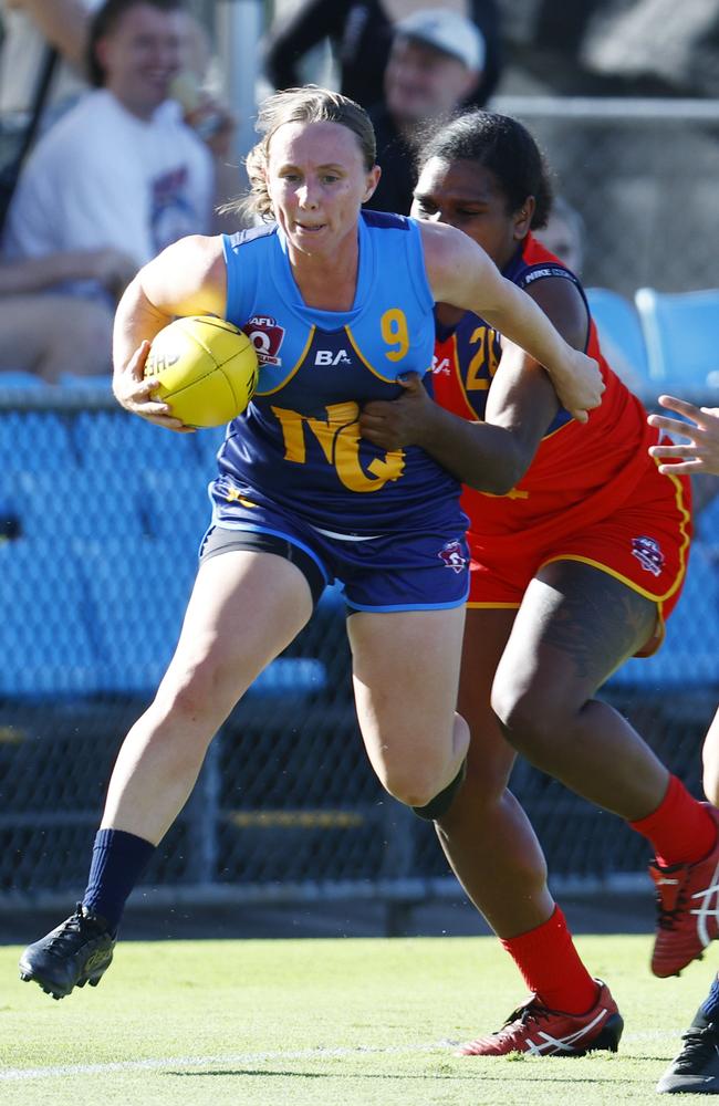 North Queensland's Amy Mill is tackled by Kitara Whap-Farrar in the AFL Queensland representative match between North Queensland and South Queensland, held at Cazalys Stadium, Westcourt. Picture: Brendan Radke