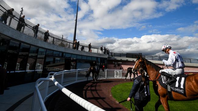 General admission punters look down on the horses and jockeys in the new Caulfield mounting yard. Picture: Getty Images