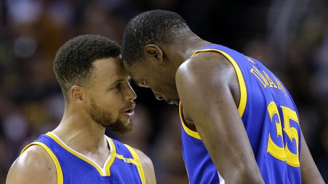 Golden State Warriors’ Stephen Curry, left, and Kevin Durant talk in the final moments.