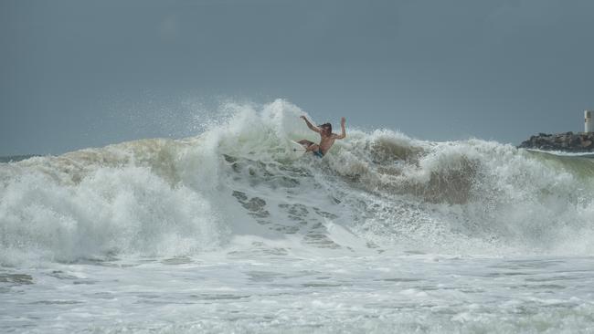 A surfer pictured making the most of the large waves at Mooloolaba Beach, Sunshine Coast during the Easter holidays. Picture: Brad Fleet