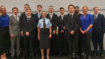 The eight graduates with Senior Constable Sharon Macrae and staff from Tudor Park PCYC’s Project Booyah.