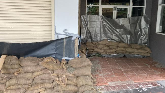 Sandbags and tarps protect Porter and Hudson florist in Picton, a small town which was put on evacuation notice on Wednesday. Picture: Adelaide Lang