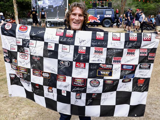 Wayne Dennis of Coombabah lined up for over 30 minutes to get Shane Van Gisbergen's signature on his chequered flag at the Gold Coast 500 V8 Supercars race. He now has every Bathurst winner's signature on the flag back to 1963 - 60 years of Bathurst winners. Picture: Brendan Radke