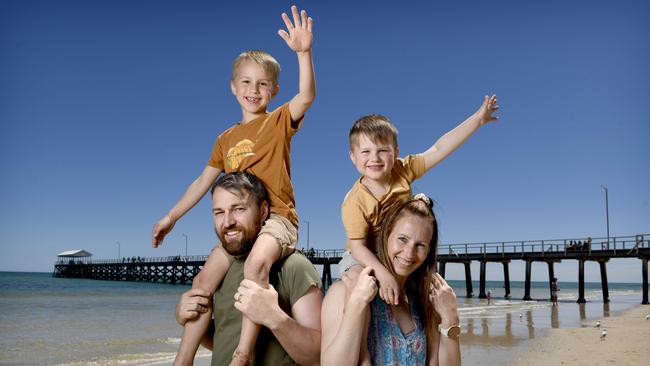 Nathan and Alana and Nathan Harvey with sons Archer, 6 and Oscar, 4 at Henley Beach. Picture: Naomi Jellicoe