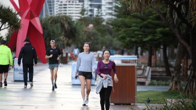 Surfers Paradise wakes up to its first day in lockdown due to the latest CoVid-19 scare. Tradesman still at work at Paradise Centre.Some consider walking a strenuous excercise and dont wear masks... Picture Glenn Hampson