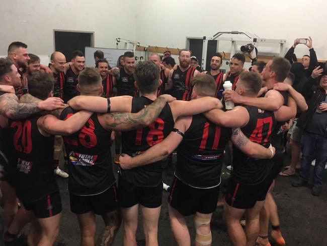 The Redbacks link arms and sing the song after winning their way through to the grand final.