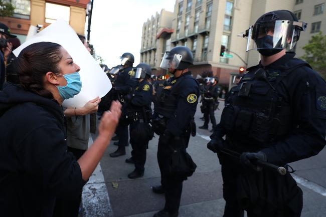 A woman shouts at police during a protest in Oakland, California. Picture: AFP