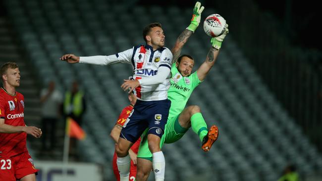 Rookie Adelaide United goalkeeper Isaac Richards is pressured by Central Coast striker Jordan Murray. Picture: Ashley Feder/Getty Images