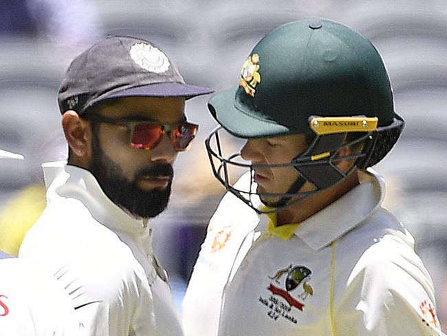 Indian captain Virat Kohli (left) and Australian captain Australian captain Tim Paine touch after Paine ran a single during play on day four of the second Test match between Australia and India at Perth Stadium in Perth, Monday,  December 17,  2018.  (AAP Image/Dave Hunt) NO ARCHIVING, EDITORIAL USE ONLY, IMAGES TO BE USED FOR NEWS REPORTING PURPOSES ONLY, NO COMMERCIAL USE WHATSOEVER, NO USE IN BOOKS WITHOUT PRIOR WRITTEN CONSENT FROM AAP