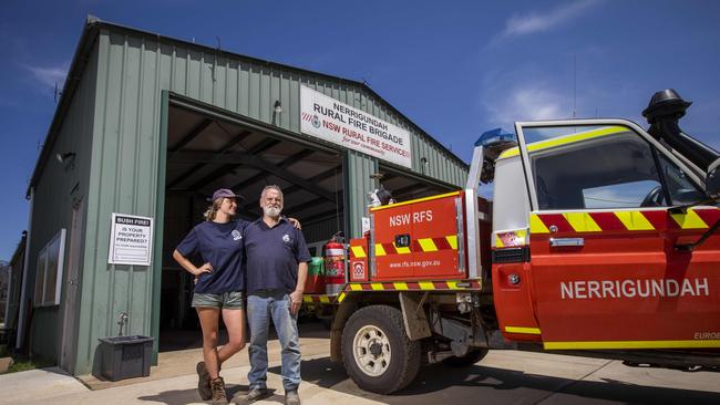 Firefighting captain Ron Threlfall and his daughter Skye, 22 at the Nerrigundah NSW Rural Fire Service shed that became their last place of refuge. The shed survived the fire due to the sprinkler system that was installed. Picture: Sean Davey.