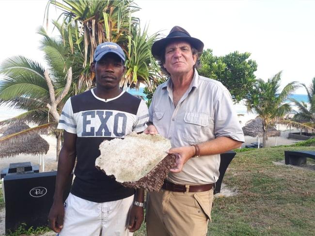 Blaine Gibson and a local fisherman in Madagascar with debris thought to be from MH370 Picture: Supplied