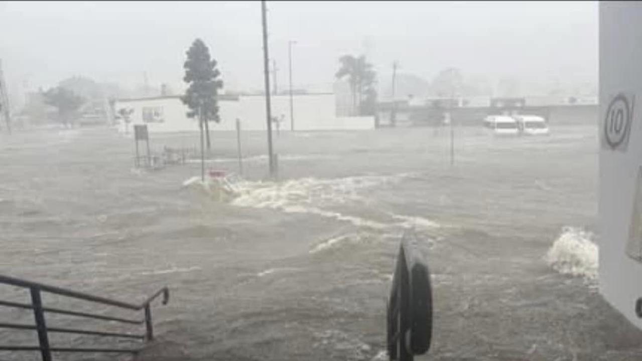 Flash flooding rockets through the carpark of Pialba Central to the RSL at Pialba in Hervey Bay during the wild weather brought by ex-Tropical Cyclone Alfred.