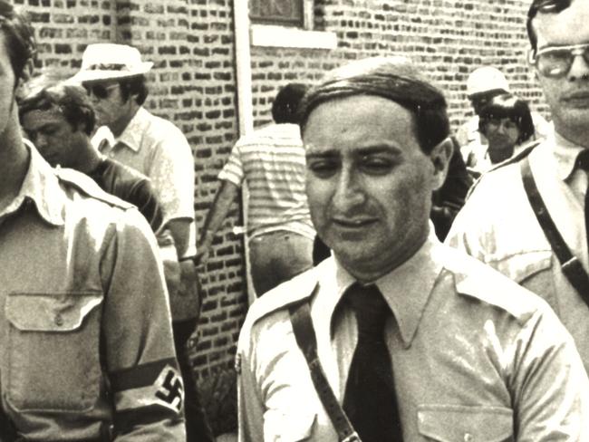 Frank Collin (centre) leaves his Nazi headquarters heading to a rally in a park in Chicago September 1978. UPI Photo