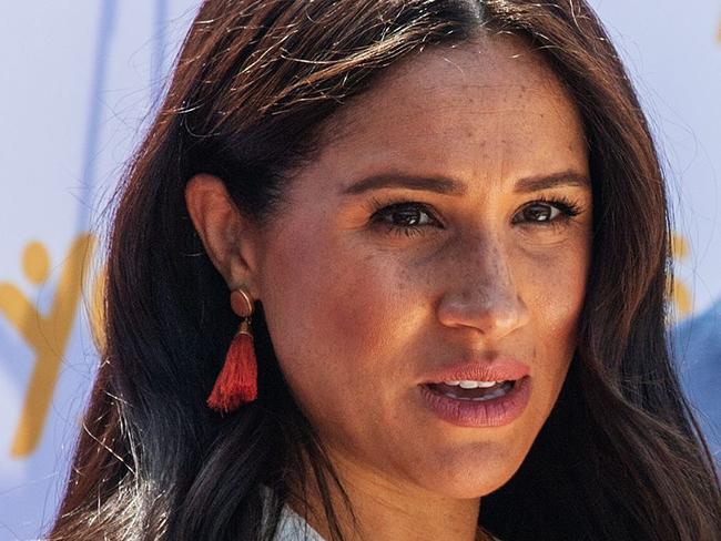 (FILES) In this file photo taken on October 2, 2019, Meghan Markle, Duchess of Sussex(L), is watched by Britain's Prince Harry, Duke of Sussex as she speaks at the Youth Employment Services Hub in Tembisa township, Johannesburg. - Markle paid tribute to George Floyd on June 4, 2020, as protests over his death in police custody sweep the nation, and expressed support for the Black Lives Matter movement. "I realized the only wrong thing to say is to say nothing because George Floydâs life mattered," Markle, who is biracial, said in a videotaped message to new graduates from her alma mater in Los Angeles, Immaculate Heart High School. (Photo by Michele Spatari / AFP)