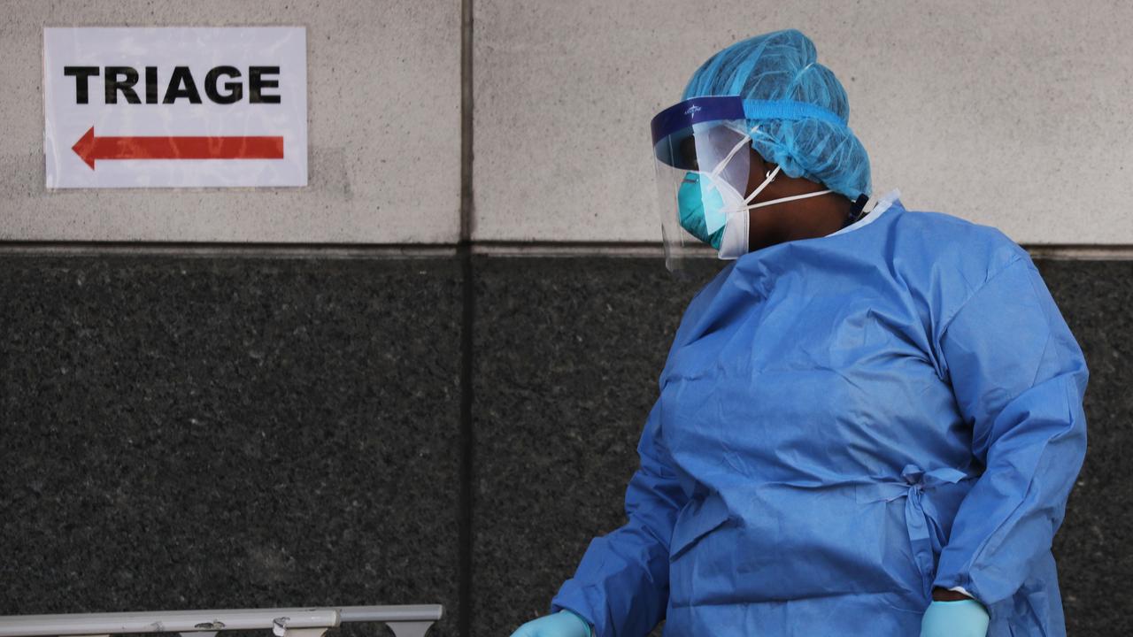 A medical worker walks outside of a special coronavirus intake area at Maimonides Medical Centre. Picture: AFP