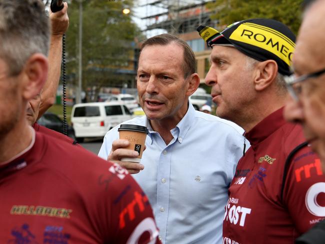 Former prime minister Tony Abbott (second left) speaks with fellow riders at Warragul before taking part in the Pollie Pedal Bike Ride today. Picture: AAP