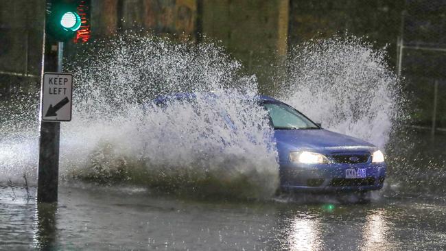 A car drives through water. Picture: Tim Carrafa