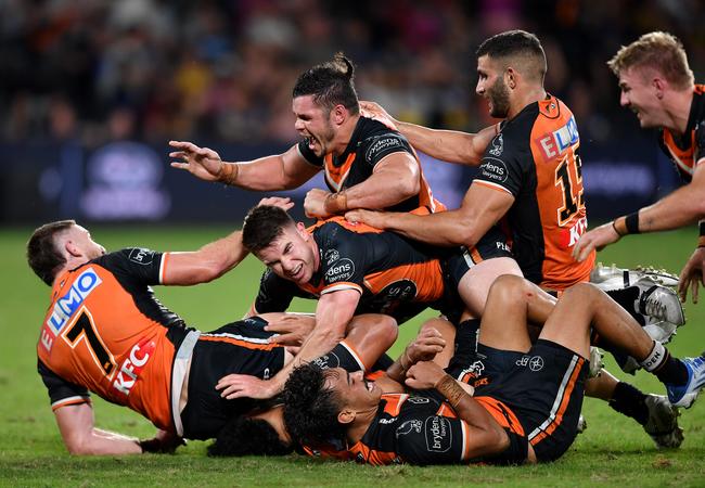 The Tigers pile on Jackson Hastings (left). Picture: NRL Images