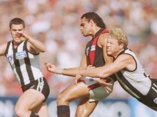 Dermott Brereton tackles Michael Long in the 1995 Anzac Day game.