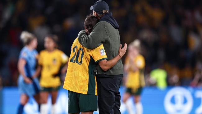 Tony Gustavsson embraces Australia's Sam Kerr. Picture: Franck Fife / AFP