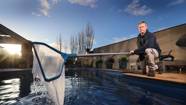 Poolwerx serviceman Matt Wyper servicing a pool, at his own home. Picture: Alex Coppel.