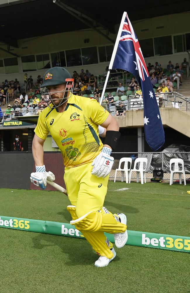 Former Australian cricketer Aaron Finch walks out onto Riverway Stadium’s field during game three of the One Day International series between Australia and Zimbabwe in 2022. (Photo by Ian Hitchcock/Getty Images)