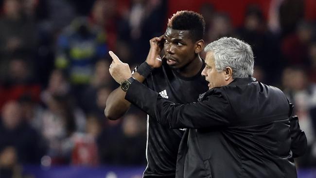 Manchester United manager Jose Mourinho, right, talks to Manchester United's Paul Pogba.