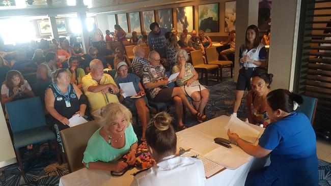 Norwegian Jewel passengers line up to apply for medicines. Picture Tom Huntley