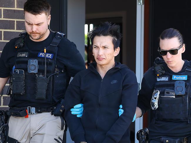 Police take a man into custody after a raid on a St Albans house. He was involved in the purchasing of luxury items using money from the stolen identity of a woman who left for China in 2015.Picture: Ian Currie