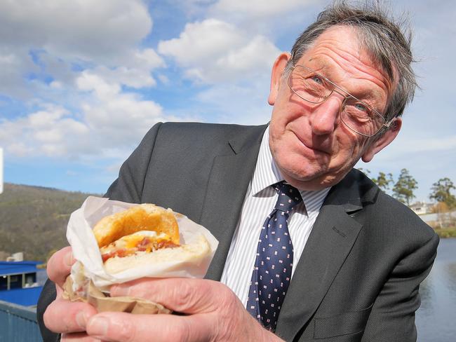 Huon Valley Mayor Peter Coat with an Egg and Bacon roll. PETA are calling for a change of the name of Eggs and Bacon Bay. Picture: RICHARD JUPE