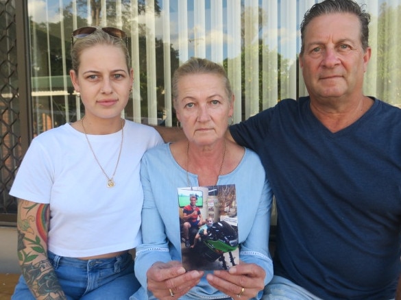 Maddy, Kathryn and Clayton Yuille, at the family home in Wingham holding a picture of Jack. Pic Daniel Mills