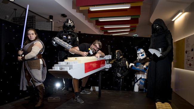 Stormtroppers helped Mark Curnow piece together the X-Wing Rebel Alliance Starfighter, which is made up of an incredible 83,442 pieces. Picture: Jerad Williams