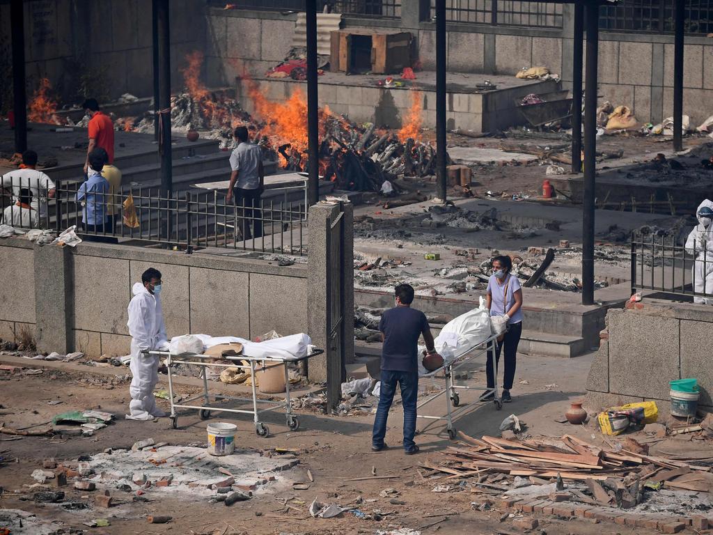 Relatives carry bodies at a crematorium in New Delhi. Picture: Tauseef Mustafa/AFP