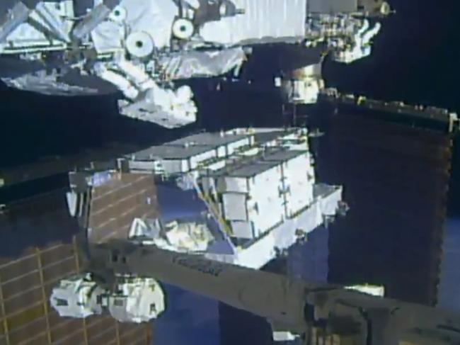 In this image made from video provided by NASA, NASA astronauts Christina Koch and Andrew Morgan work outside the International Space Station, Sunday, Oct. 6 2019.  The astronauts kicked off the first of five spacewalks to replace old batteries at the International Space Station on Sunday. (NASA via AP)