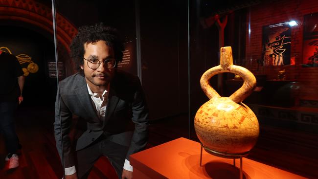 Sydney university archaeologist Jacob Bongers with a sacrifice ceremony and presentation cup at the Machu Picchu and the Golden Empires of Peru exhibition. Picture: John Feder