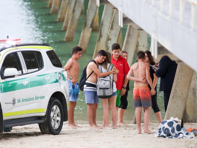 People console each other after the drowning of Eliase Nimbona. Picture: AAP / Russell Millard