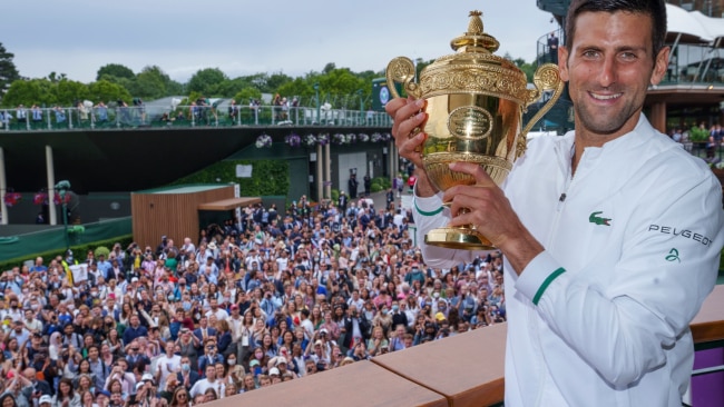 Novak Djokovic celebrates with the trophy on the balcony of the Clubhouse after winning his sixth Wimbledon title at All England Lawn Tennis and Croquet Club. Photo by AELTC/Bob Martin - Pool/Getty Images