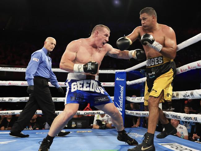 Paul Gallen throws a punch at fellow ex-NRL star Justin Hodges in 2022. Picture: Getty