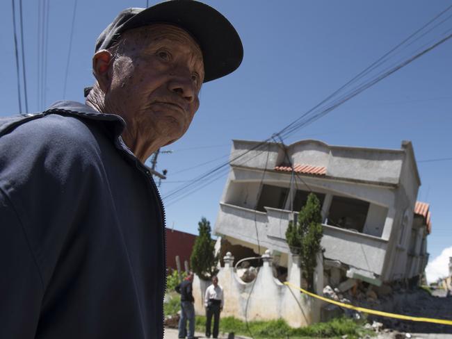 A man stands close to homes that collapsed during an earthquake in San Pedro, Guatemala, on Monday. Picture: AP Photo/Oliver de Ros