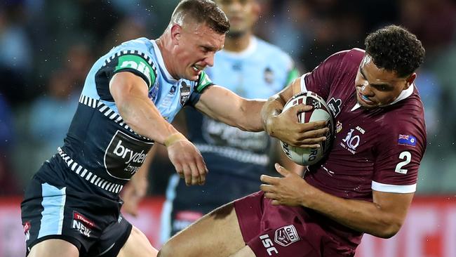 Queensland winger Xavier Coates is hit in a tackle by Jack Wighton Picture: Getty Images