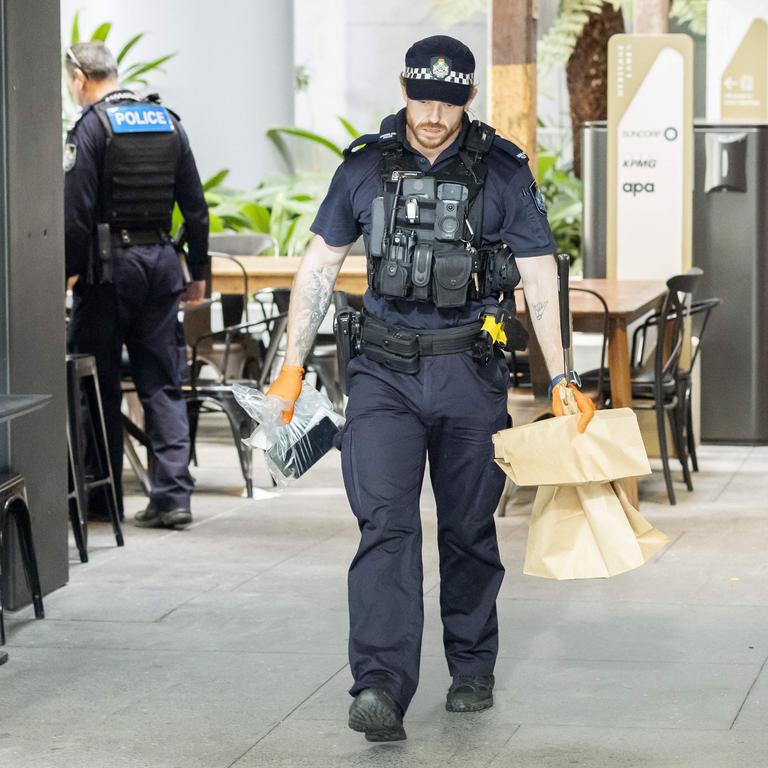 Police combing the scene of a stabbing in Brisbane’s CBD today. Picture: Richard Walker