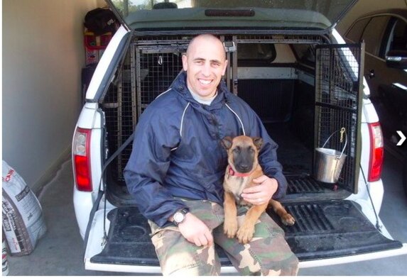 Senior Constable Dellow and Arkie as a little puppy.